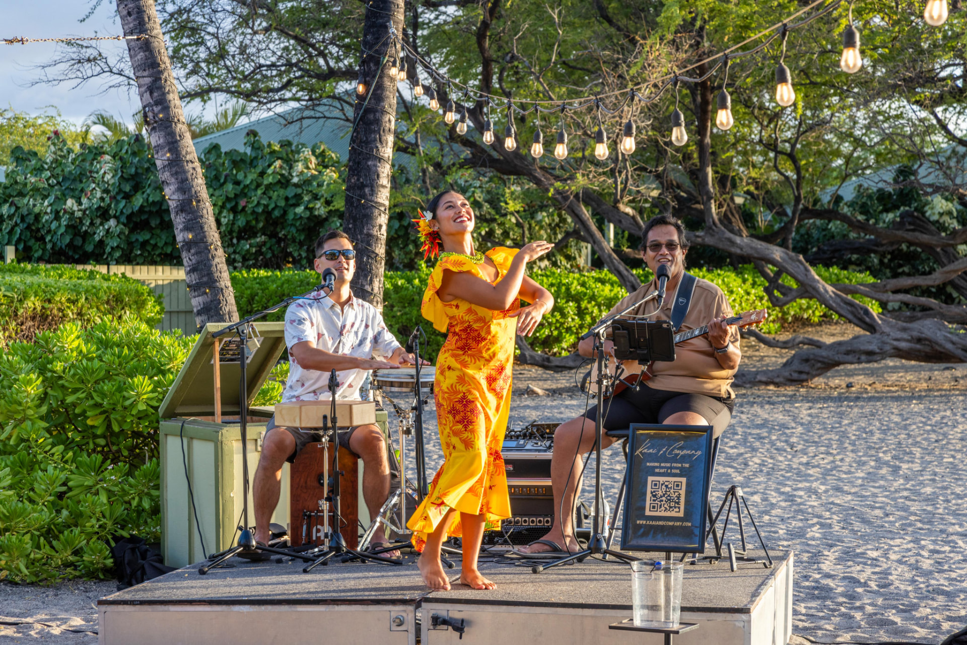 Hula dancer performing with a live band on the beach stage