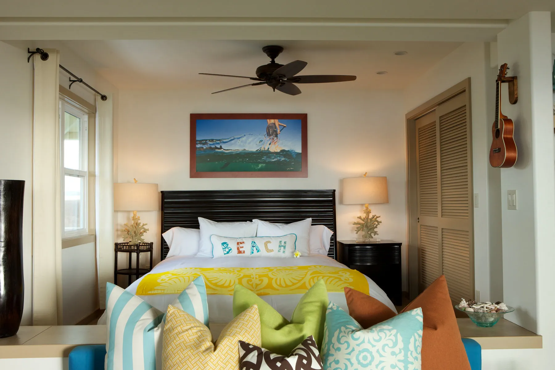 Bright cottage bedroom opening onto an oceanfront lanai