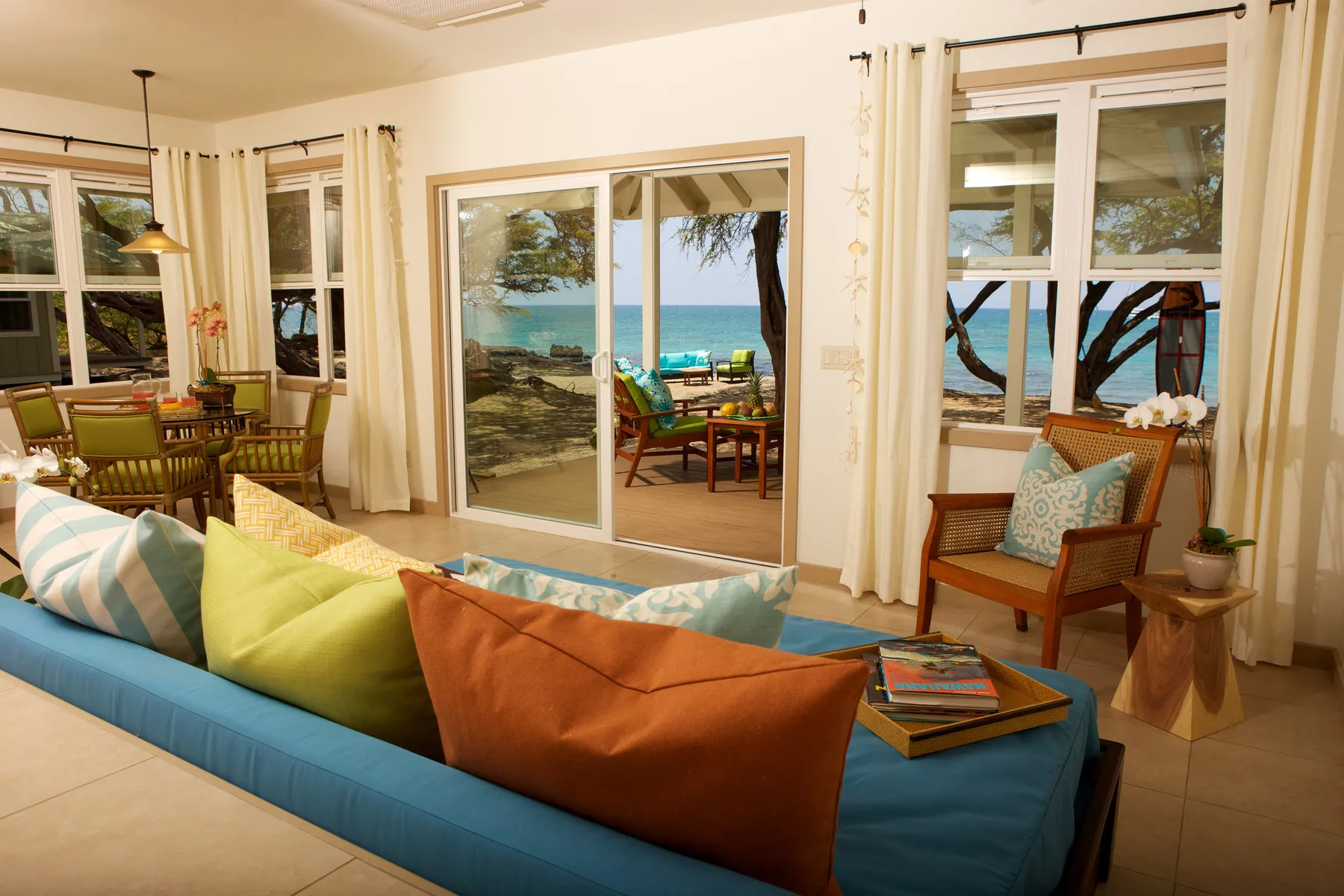 Cottage living area with open doors and ocean views
